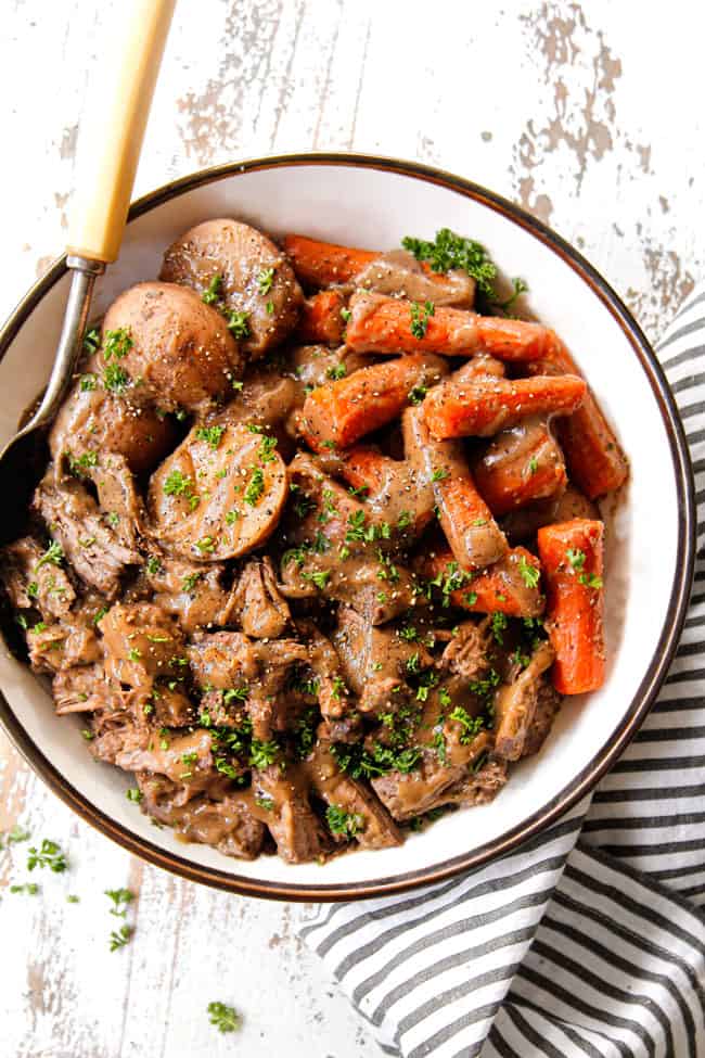top view of serving crock pot roast recipe on a platter with gravy