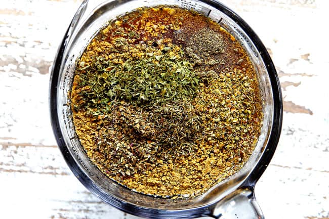 showing how to cook a roast in a crock pot by whisking together beef broth, Worcestershire sauce, soy sauce and Italian seasonings