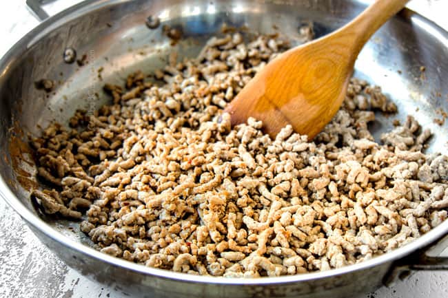 showing how to make homemade egg rolls by browning pork in a skillet