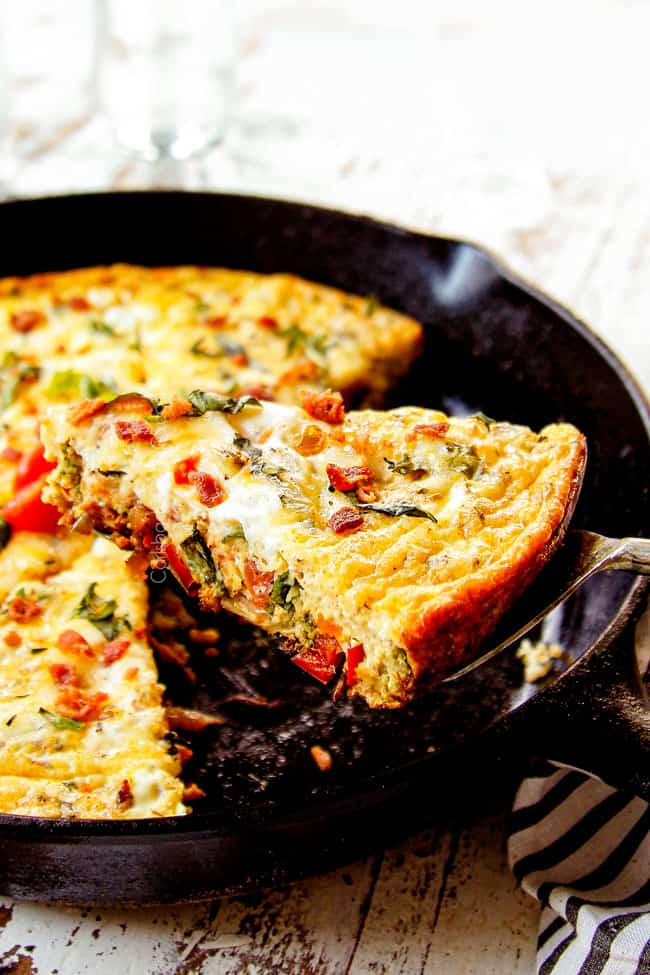 showing how to serve egg frittata recipe by removing a slice from the pan
