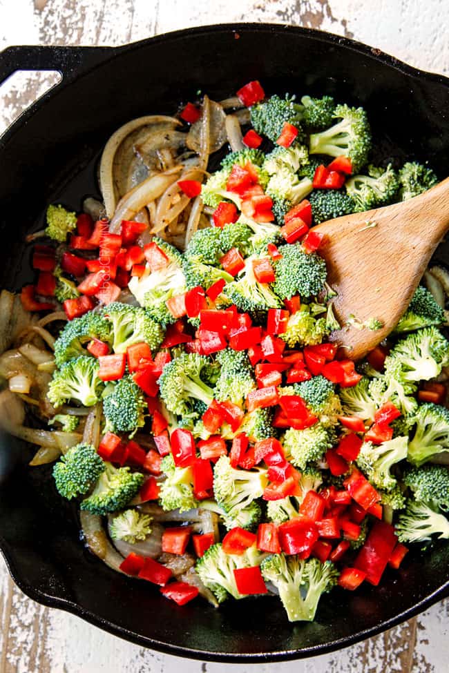showing how to make frittata recipe by sauteing broccoli and bell peppers with onions in a cast iron skillet