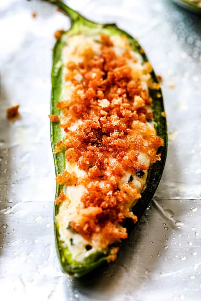 up close of the best jalapeno poppers coming out of the oven with cream cheese filling