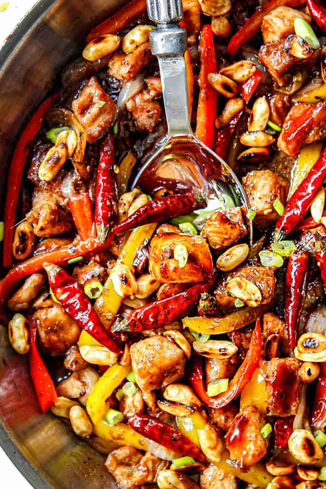showing how to make chicken szechuan style by stirring the chicken and veggies together