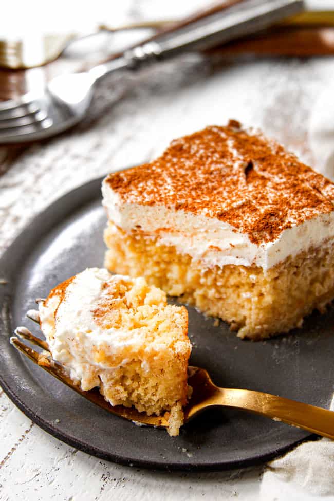 a bite of authentic tres leches cake on a gold fork