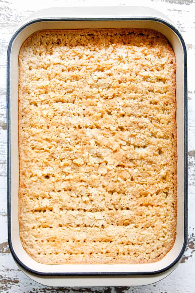 showing how to make easy tres leches cake by poking all over with holes