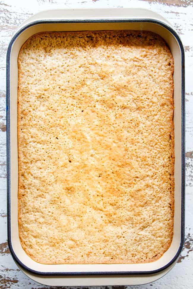 showing how to make best tres leches cake by baking until golden