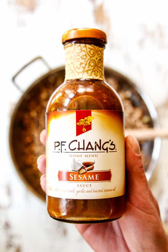 showing how to make Egg Roll in a Bowl by adding sesame sauce, and soy sauce to pork