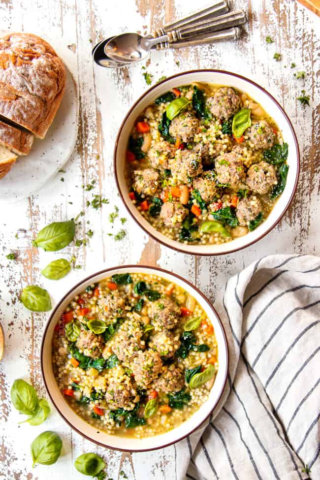 top view of showing how to serve Italian Meatball Soup recipe by garnishing with parsley and basil