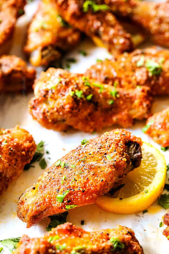 up close of lemon pepper chicken wings garnished with parsley