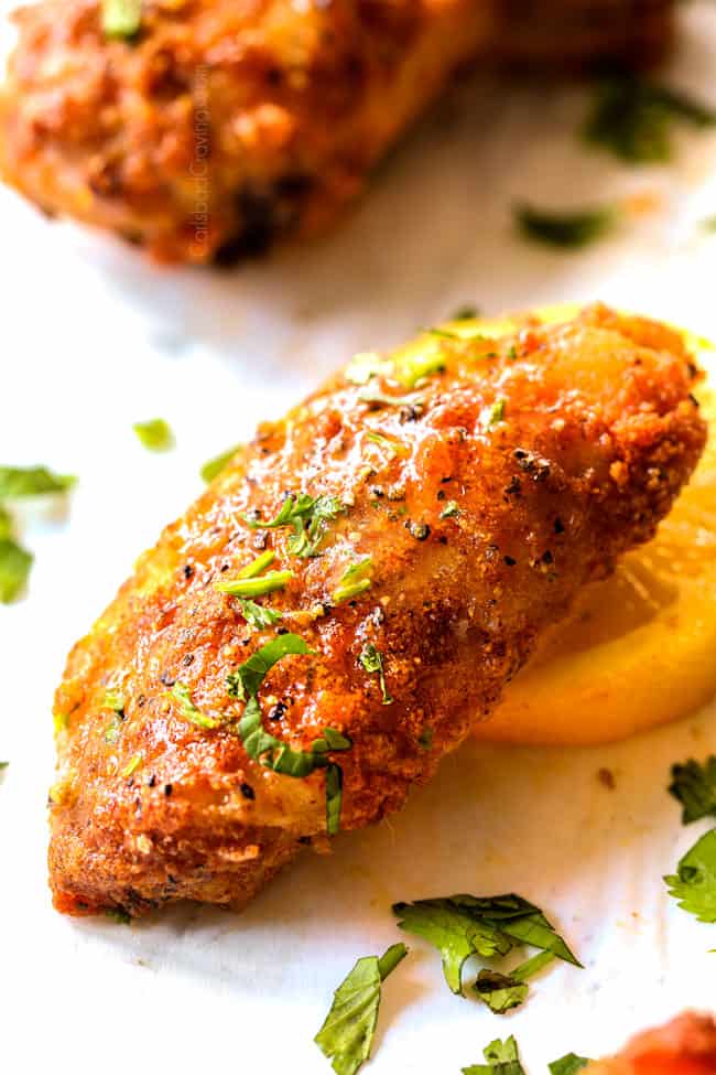 up close showing how to serve baked lemon pepper chicken wings by serving with ranch dip