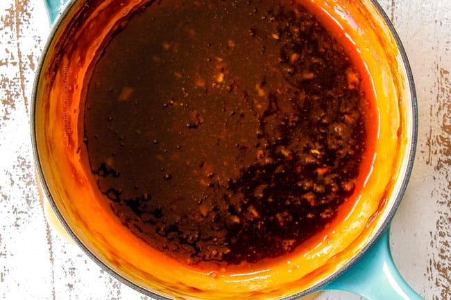 showing how to make orange chicken by simmering sauce to thicken