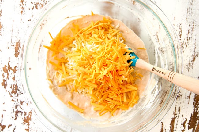 showing how to make crab dip by mixing cream cheese, sour cream and mayonnaise until smooth then adding cheddar cheese