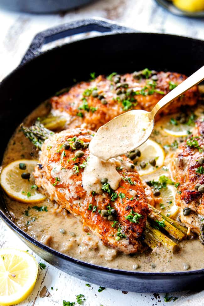 showing how to make Chicken Piccata by drizzling lemon sauce on top of a chicken breast in the skillet
