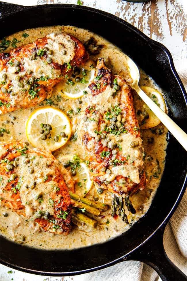 top view of showing how to serve Chicken Piccata by garnishing with parsley