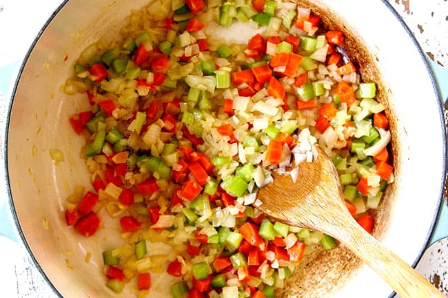 showing how to make chicken and rice recipe by cooking carrots, celery and onions in a Dutch oven