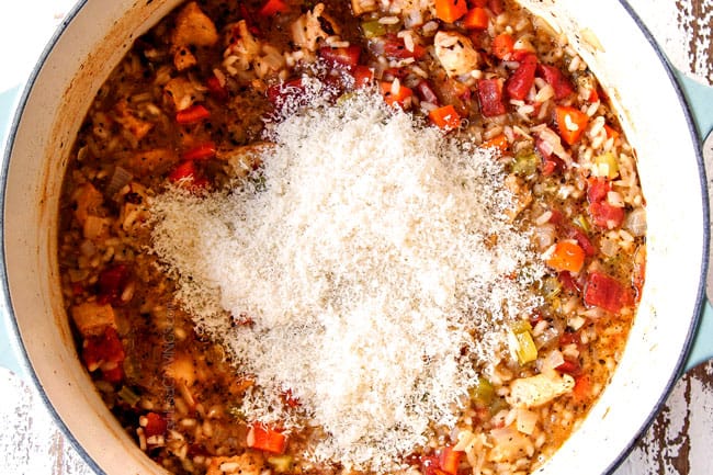 showing how to make creamy chicken and rice recipe by adding Parmesan cheese and mozzarella cheese to baked chicken and rice