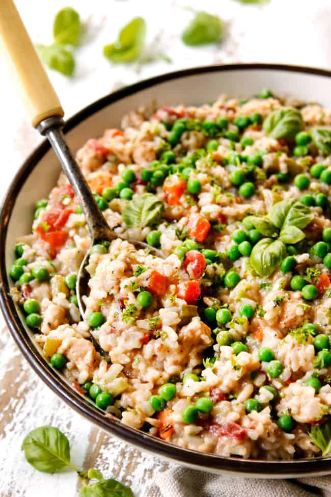 side view of serving Creamy Chicken and Rice recipe from a large serving bowl