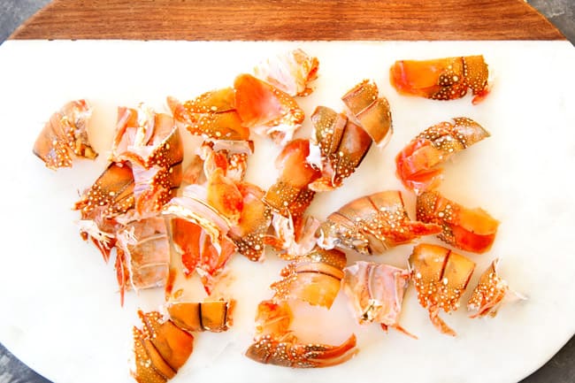 showing how to make lobster bisque by cutting lobster tails into pieces