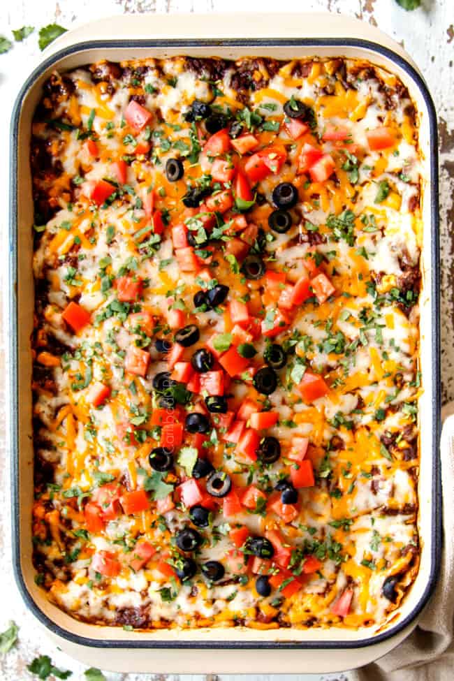 showing how to garnish Mexican Lasagna recipe with a top view of the lasagna with tomatoes, olives and cilantro
