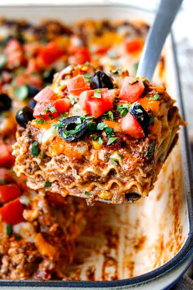 up close of a piece of lasagna on a spatula being served