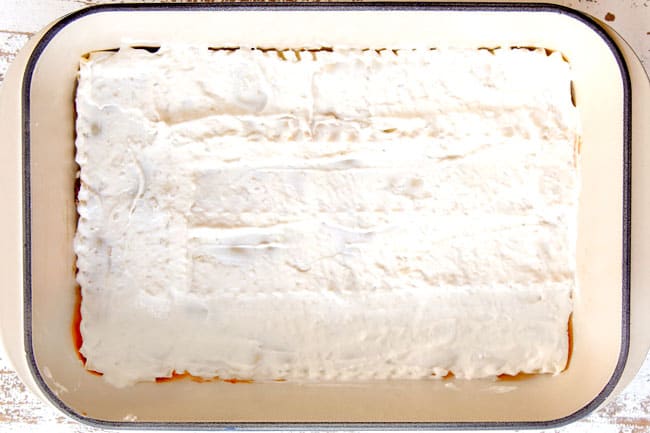 showing how to make Mexican Lasagna recipe by layering lasagna noodles with creamy sour cream layer