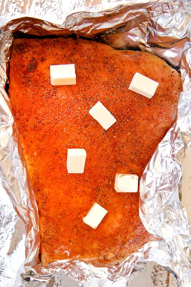 showing how to make salmon pasta by seasoning salmon with garlic powder, onion powder, salt and paprika before baking