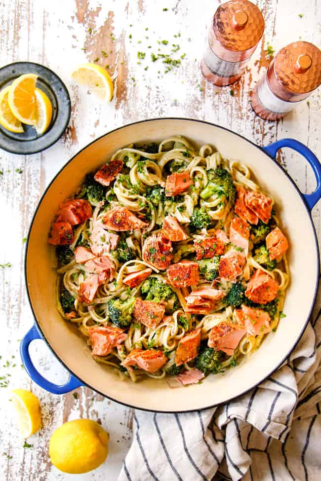 top view of making salmon pasta recipe by tossing salmon with creamy sauce, pasta and broccoli