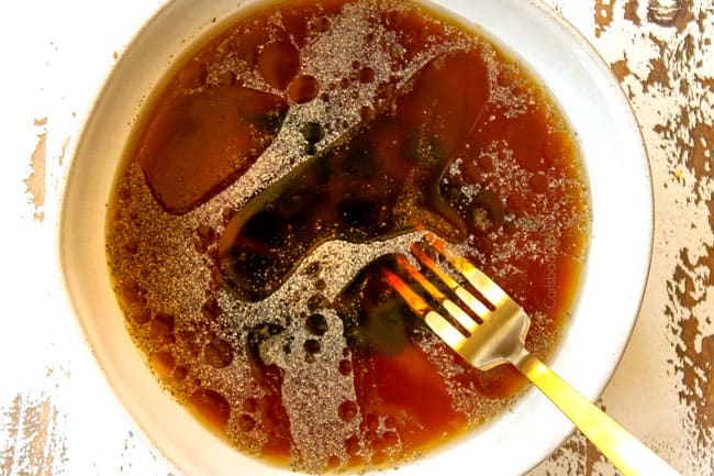 showing how to make Singapore Style Noodles by whisking the sauce ingredients together in a medium bowl