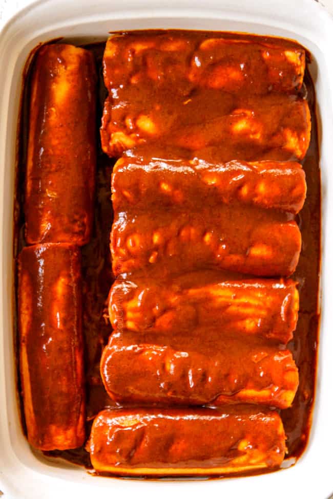 showing how to make easy chicken enchiladas by placing rolled tortillas with filling seam side down in a 9x13 baking dish