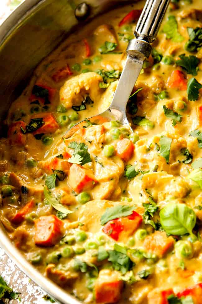 showing how to serve Green Curry Chicken by scooping curry up with a a spoon