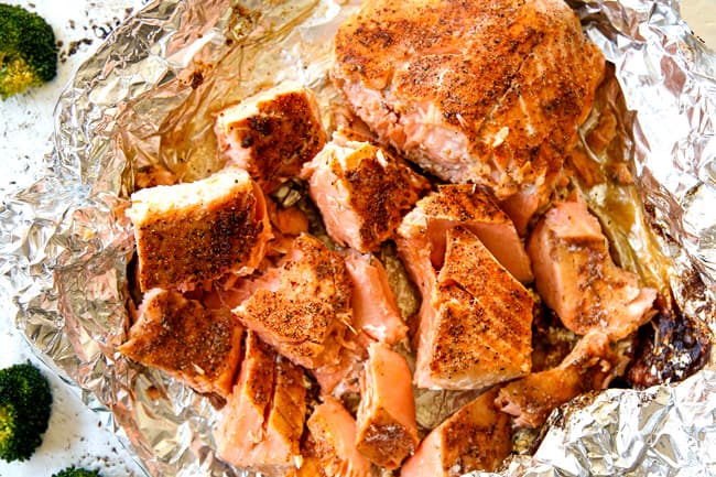 showing how to make salmon pasta by flaking salmon into chunks before adding to pasta