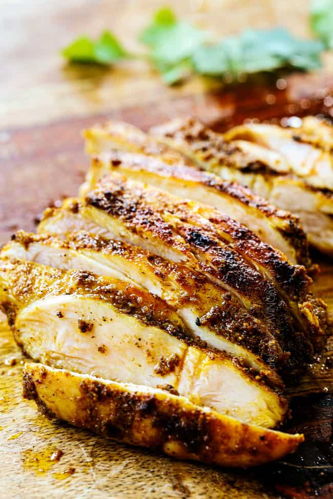 showing to make chicken shawarma wraps by slicing chicken shawarma thinly