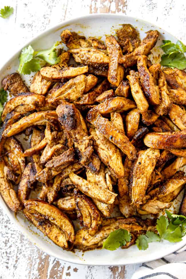 showing how to make shawarma by slicing chicken thinly and adding to a platter to serve