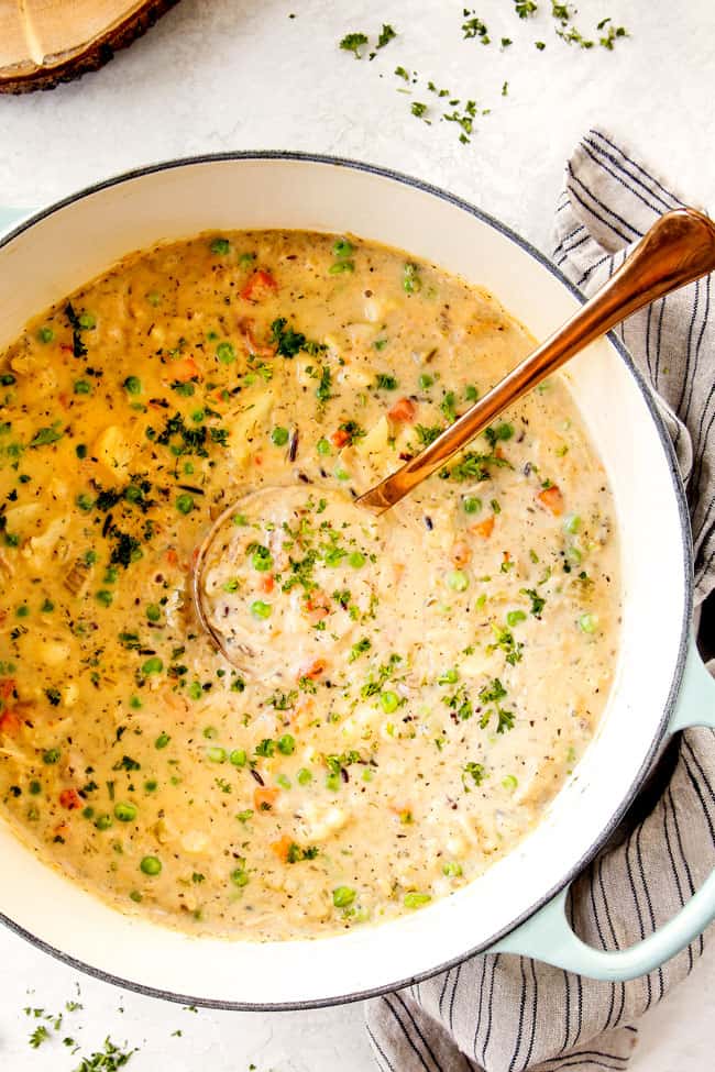 top view showing how to make chicken and rice soup with wild rice by stirring in peas