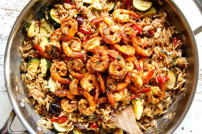 showing how to make Lemon Garlic Shrimp by adding cooked shrimp to pasta