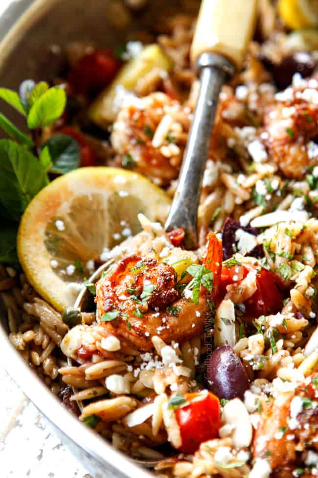 up close of a spoon serving lemon garlic shrimp with pasta