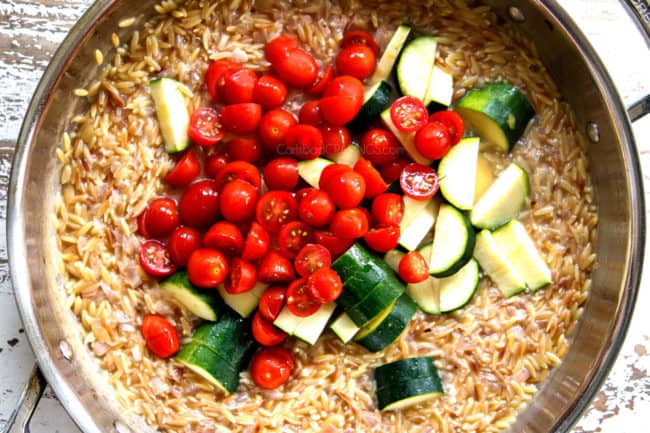 showing how to make Lemon Garlic Shrimp by adding zucchini and tomatoes