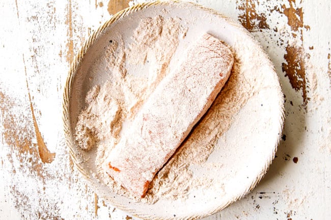 showing how to make lemon salmon and asparagus by dredging salmon in flour
