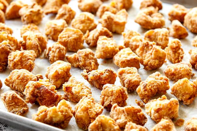 showing how to make sweet and sour chicken by cooking chicken until crispy