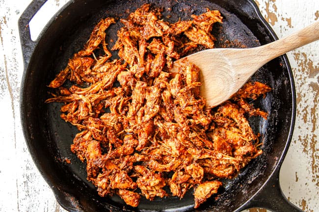 showing how to make chicken tostadas by shredding chicken