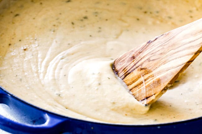 showing how to make Tuna Casserole by stirring in sour cream