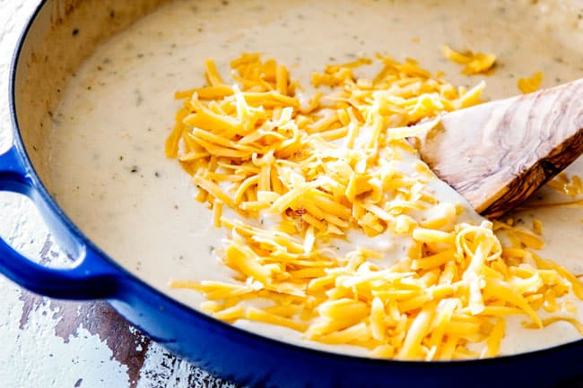 showing how to make Tuna Casserole recipe by stirring cheddar cheese into Mornay sauce