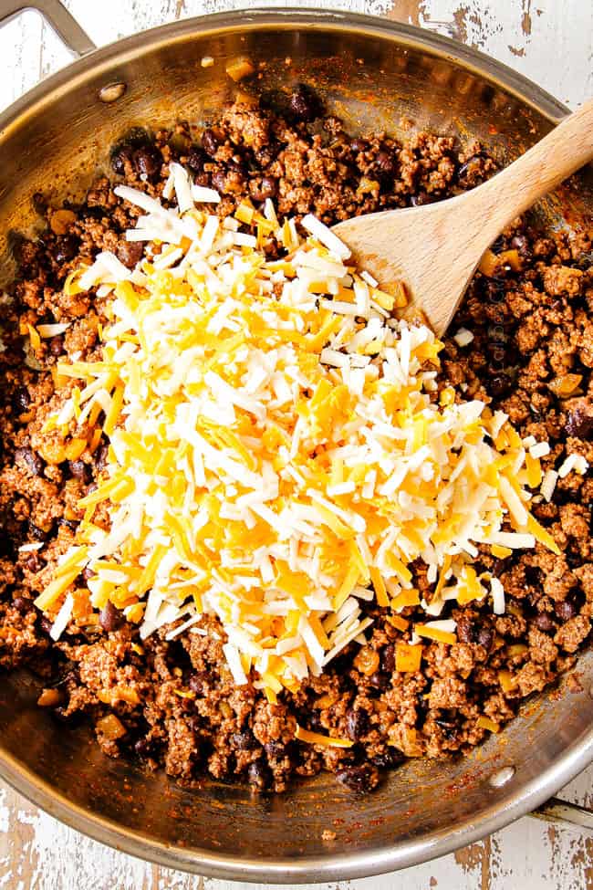 showing how to make ground beef enchiladas by adding sharp cheddar and Monterrey Jack cheese to ground beef
