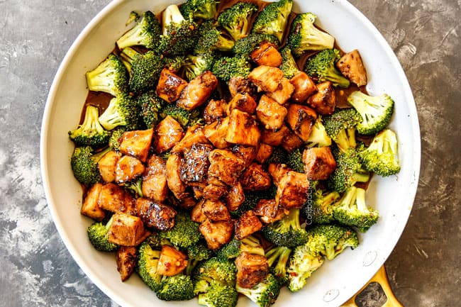 showing how to make Chinese Chicken and Broccoli recipe by adding chicken and stir fry sauce to broccoli in skillet