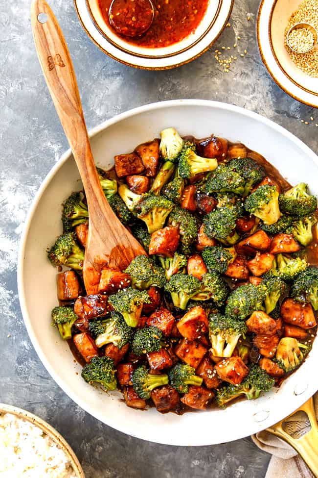 showing how to make Chicken and Broccoli stir fry with a top view of the sauce in the skillet simmering until  thickened 