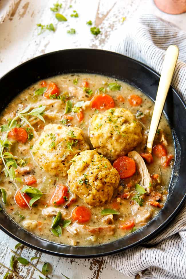 showing how to serve homemade chicken and dumplings recipe by adding dumplings to top of bowl of soup