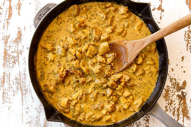 showing how to make peanut butter chicken by simmering until thickened