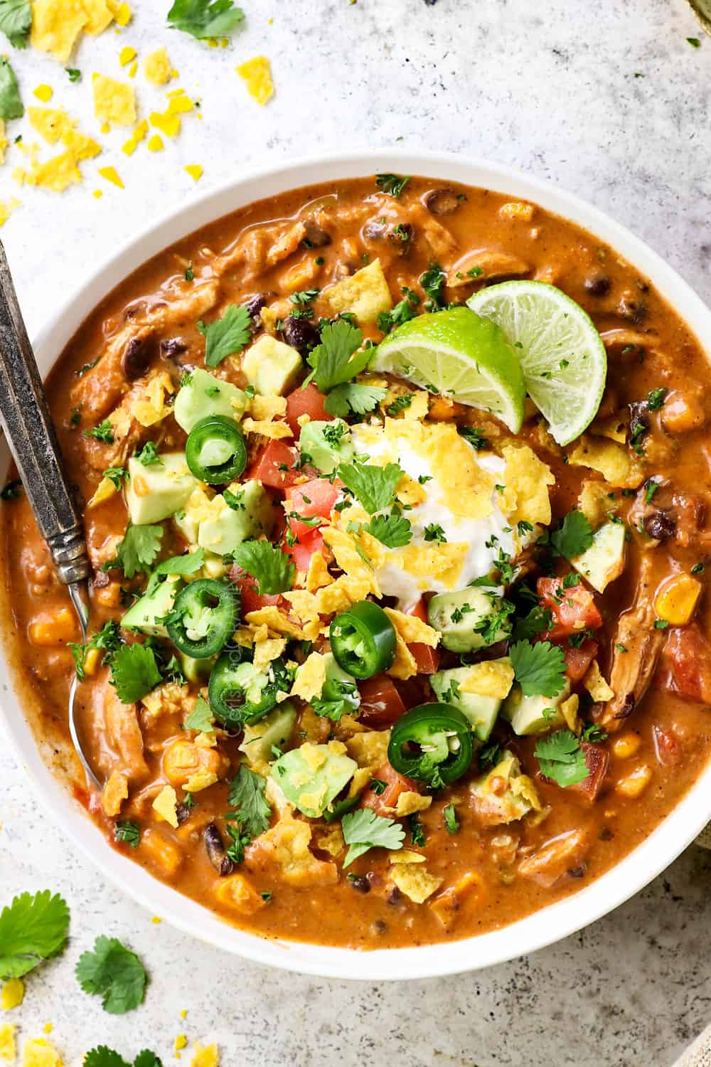 top view of a bowl of chicken enchiladas soup recipe to show how cheesy it is