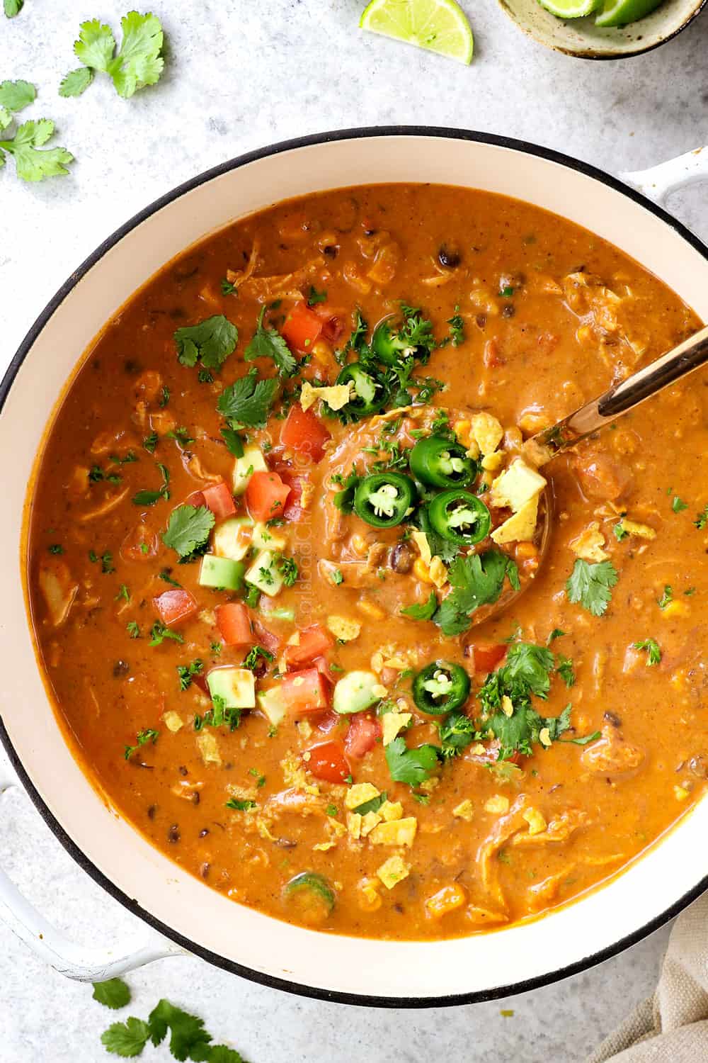 top view showing how thick Chicken Enchilada Soup recipe is by scooping up the soup