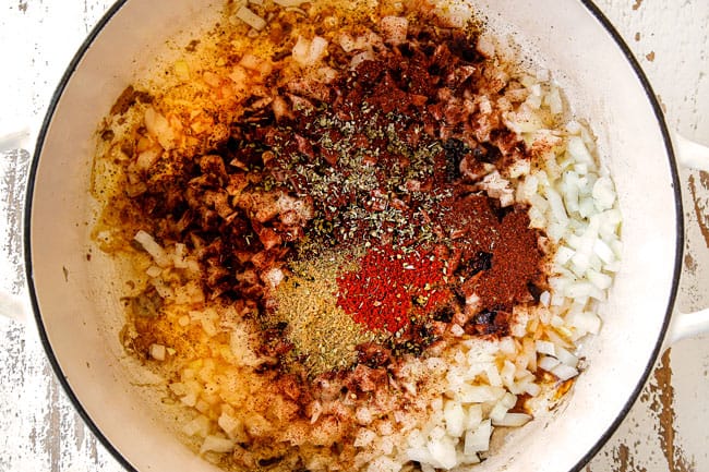 showing how to make Chicken Enchilada Soup recipe by cooking onions and chili powder, ground cumin and smoked paprika